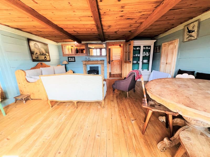 wooden floor, wooden ceiling, fireplace, wooden furniture, blue walls, wooden table, wooden chairs
