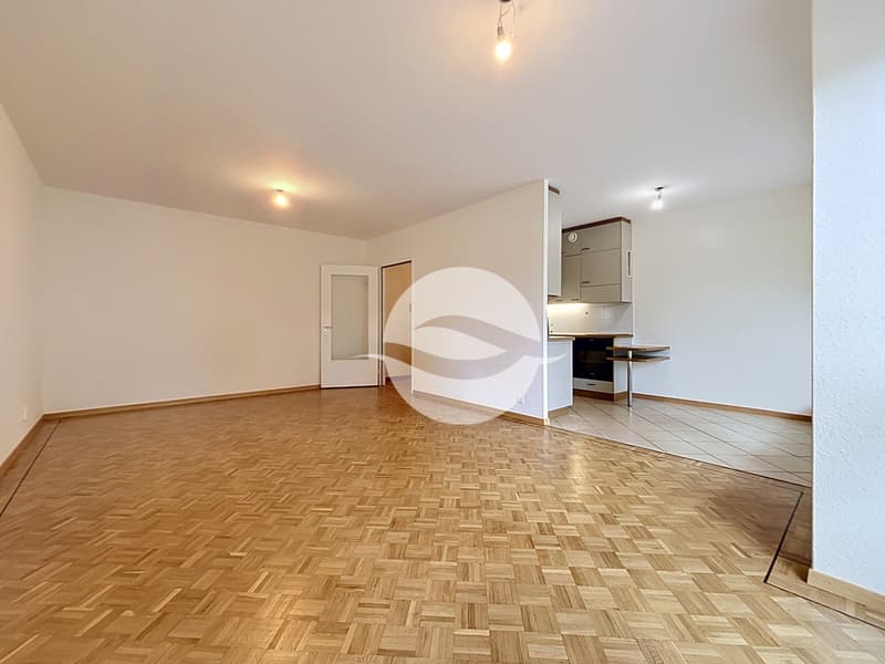 Spacieux séjour avec parquet mosaïque entouré d'une frise