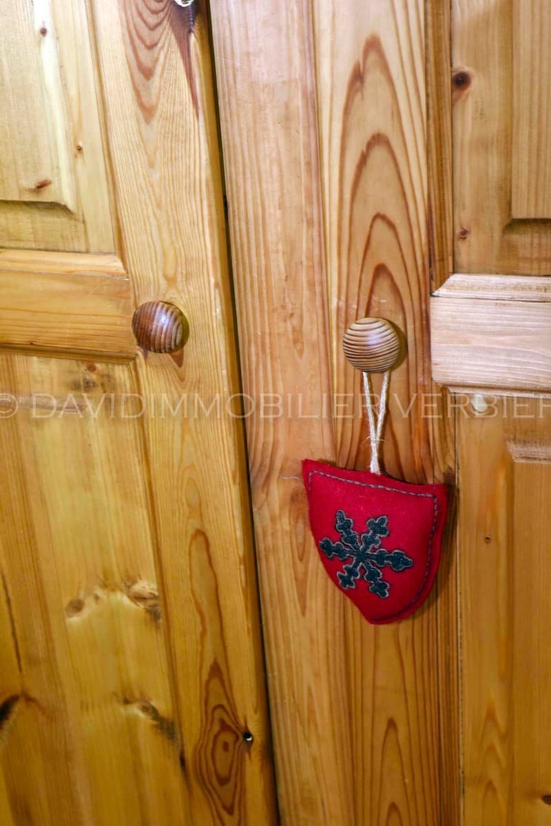 wooden closet, red snowflake ornament, wooden handle