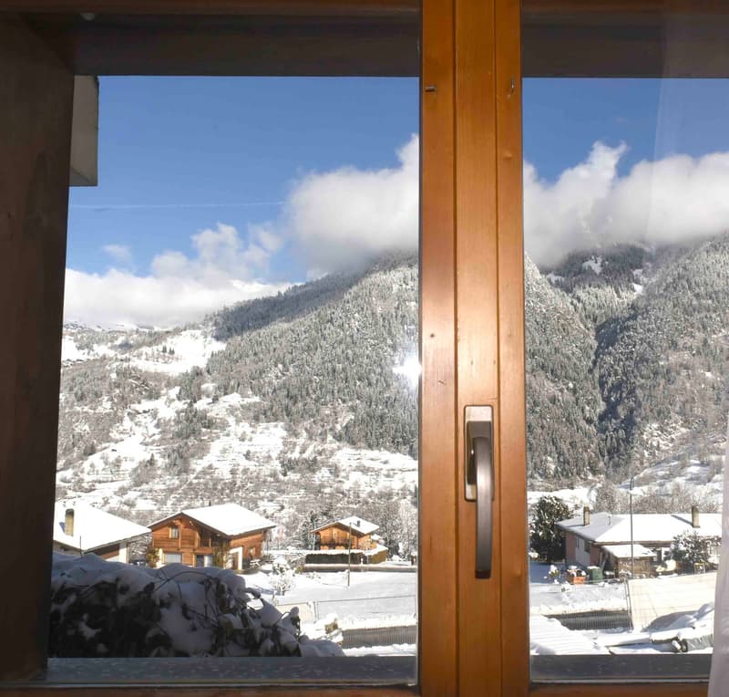 Window frame, wooden, outside mountain view with snow