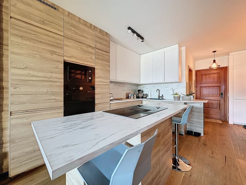 island kitchen, marble counter, stove, oven, white cabinets, wooden cupboards, faucet, kitchen tools, floor