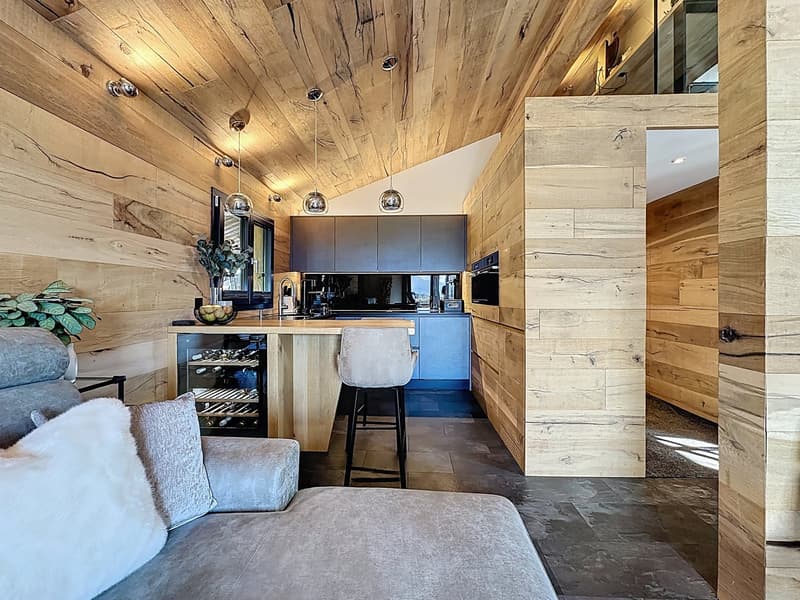 kitchen island, seating area, wooden wall panels, ceiling lights