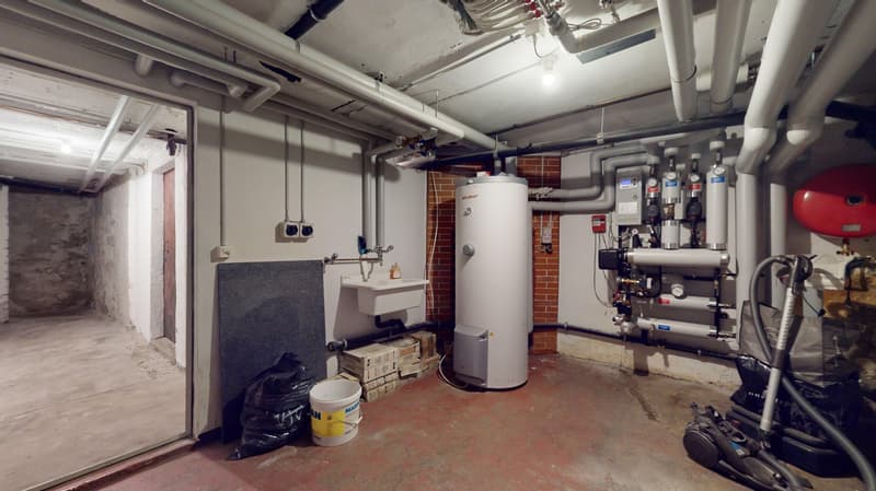 Water heater, storage boxes, sink, bins, trash bags, pipes, and equipment.