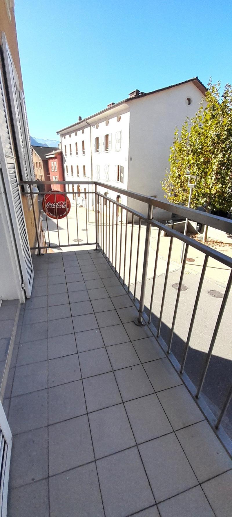 Building exterior with balcony, street view, Coca-Cola advertisement sign