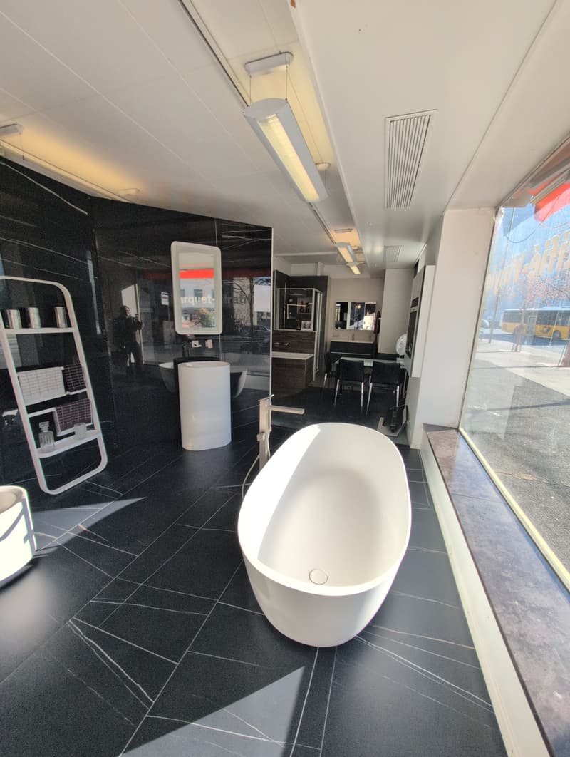 shower, white bathtub, white sink, black tiles, glass wall, lamps