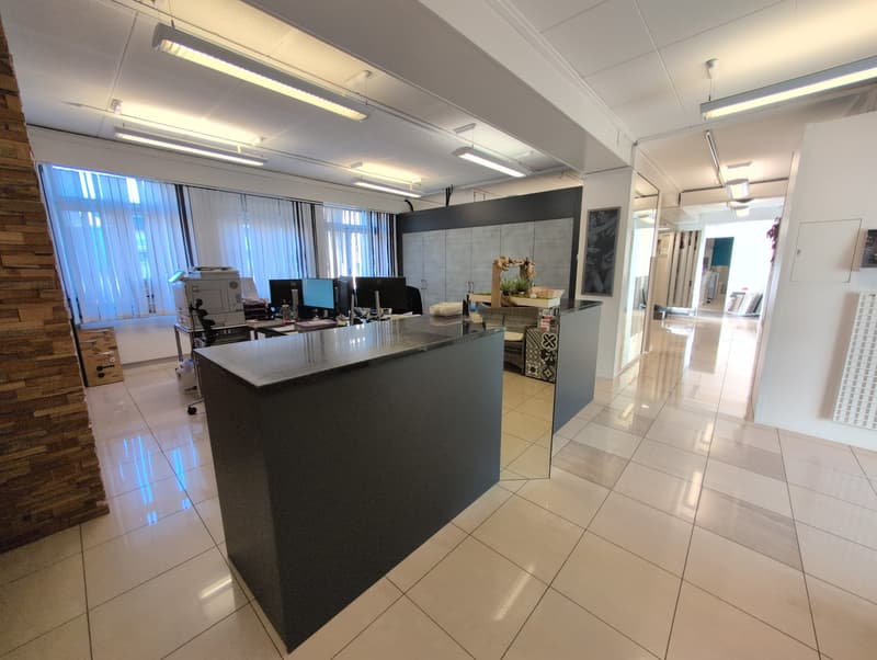 modern office, black granite counter, white tile flooring, fluorescent ceiling lights, large windows, office equipment