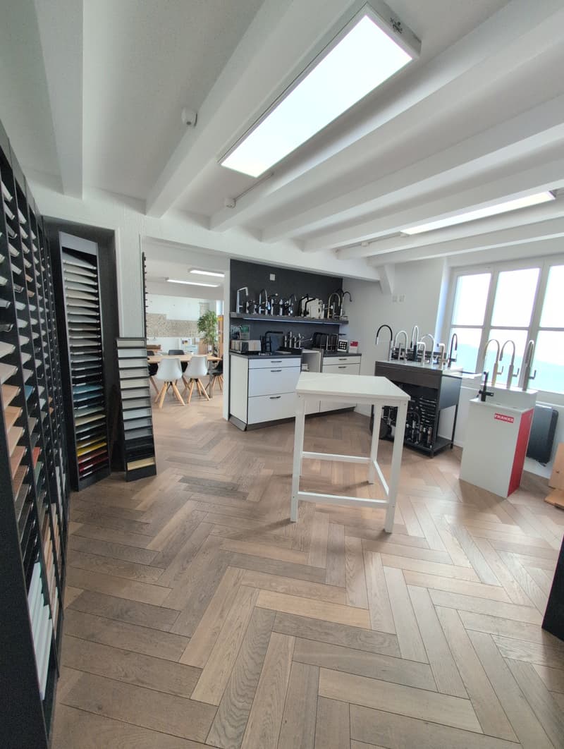 modern interior, wooden parquet flooring, white high ceilings, large table, large window