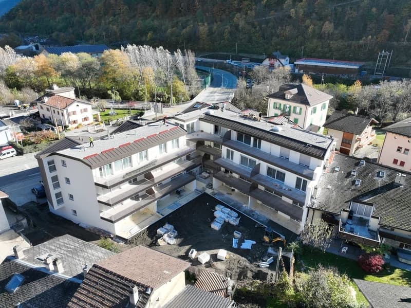 4 story building, balconies, windows, roof, driveway, vehicles parked, landscape area, trees