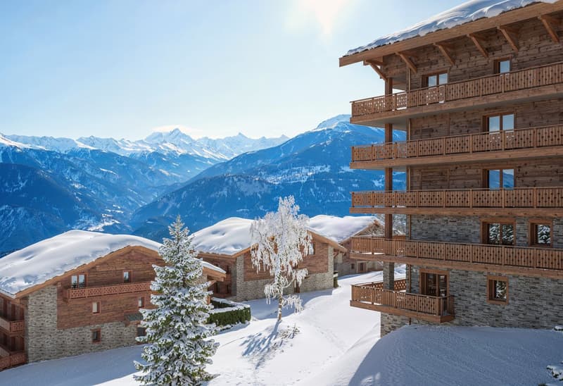 wooden chalets, snow-covered roofs, balconies, pine trees, snowy mountains