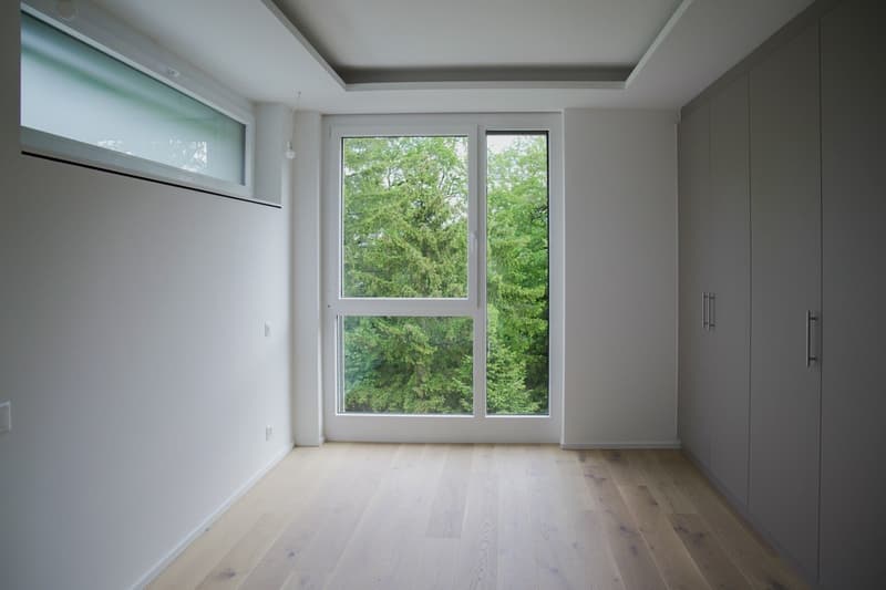 empty room, white walls, wooden floor, large window, glass door, white ceiling, built-in wardrobes