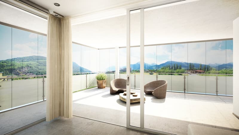 Balcony with panoramic views of mountains and a lake, two armchairs, wooden coffee table, potted plant