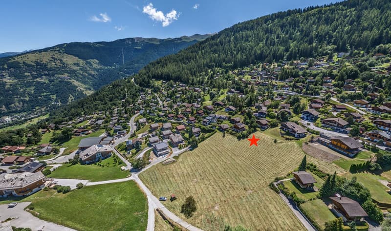 Mountain area with many houses, fields, road, greenery