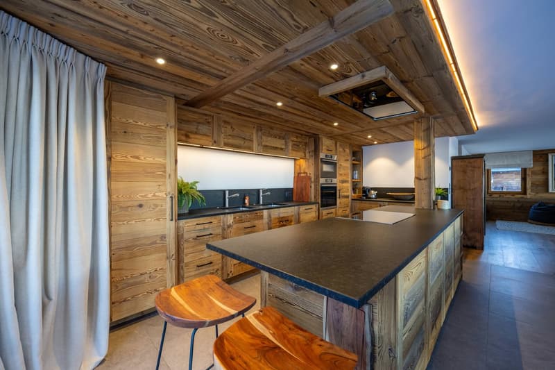 kitchen island with granite countertop, wooden cabinets, open shelves, stainless steel sinks, faucets, wooden stools, kitchen appliances