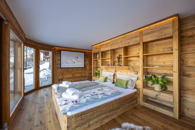 wooden floor, bed, wooden shelves, plants, outdoor view
