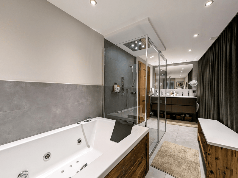 Walk-in shower, jacuzzi bathtub, wooden flooring, wooden bench, built-in countertop, mirror, wooden vanity, double sinks, frame on the wall