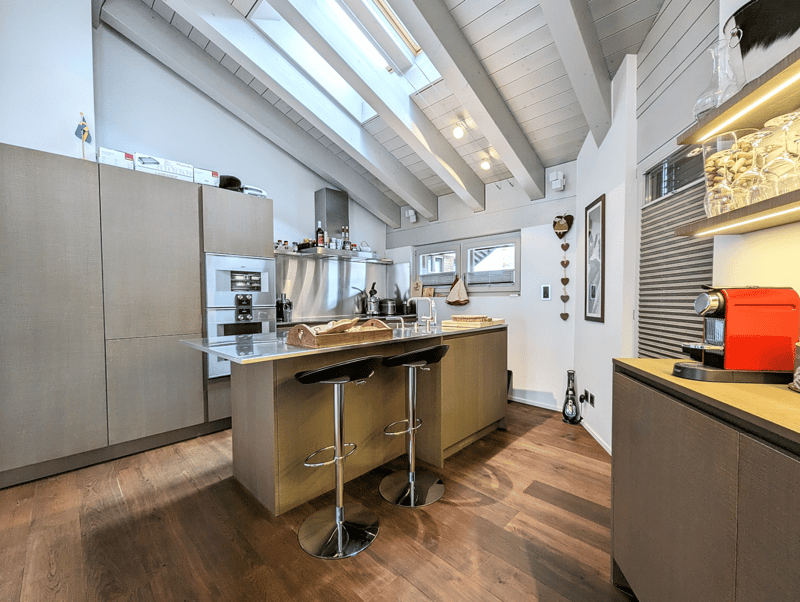 central island, stools, countertops, microwave, oven, refrigerator, skylight, wood floors