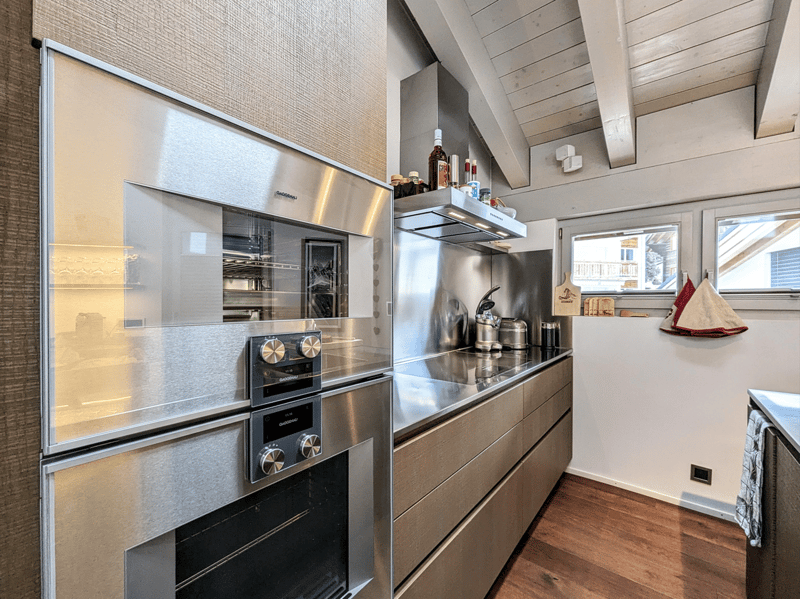 Stainless steel appliances, wooden floors, large windows, modern design
