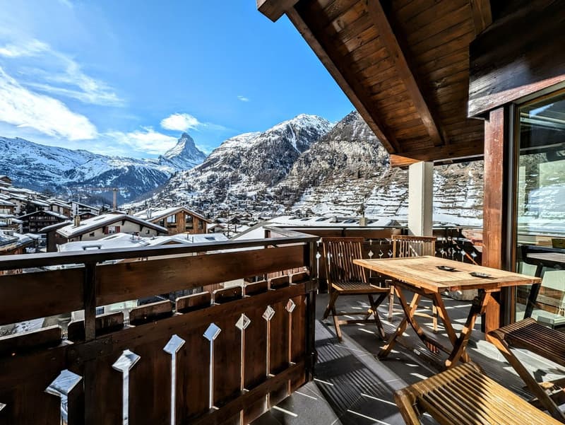 wooden balcony, metal railing, outdoor furniture, scenic mountain view