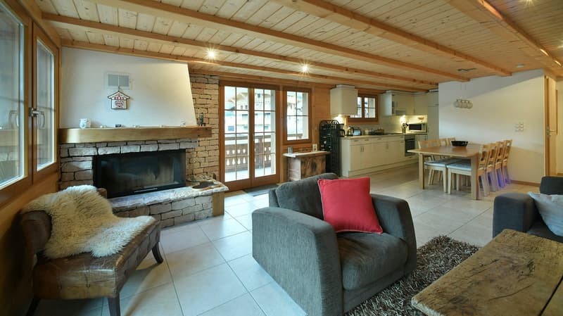 living room with fireplace, rug, sofa, chair, table, dining table, kitchen