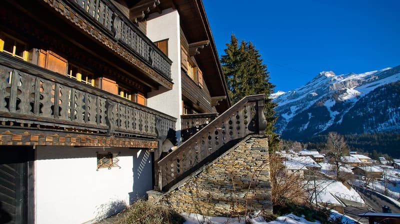 white and brown exterior, balcony, stone staircase, mountainous backdrop