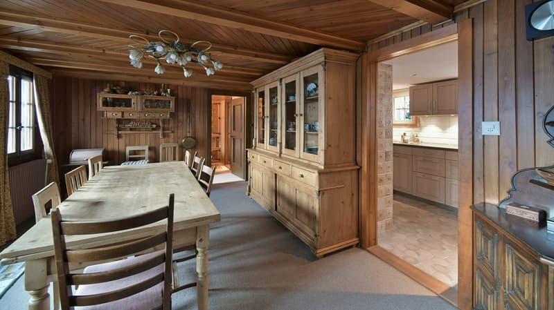 wooden dining table, wooden chairs, wooden cabinet, chandelier, tiled floor, adjacent room