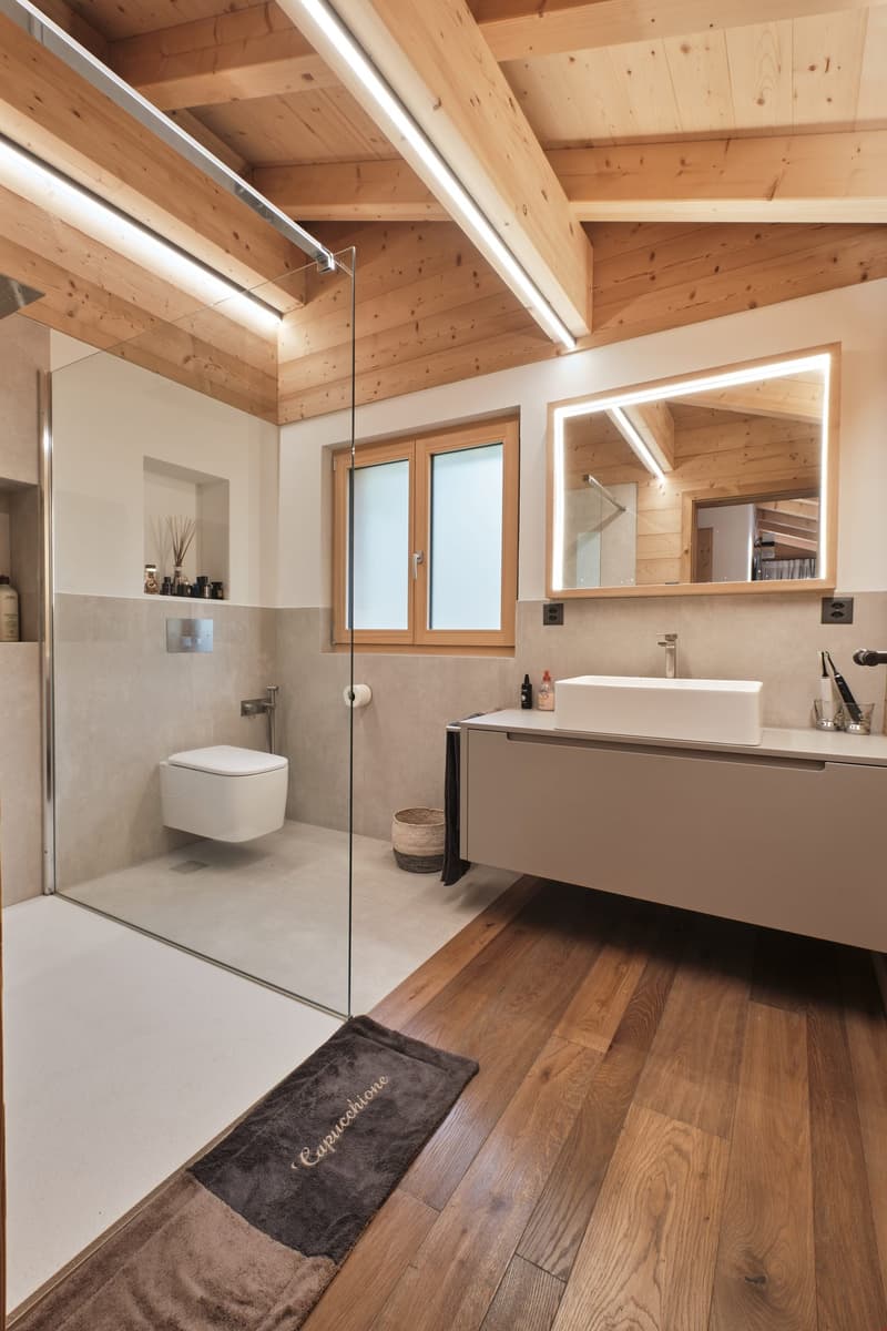 wooden walls and floor, shower, toilet, sink, mirror, wooden beams