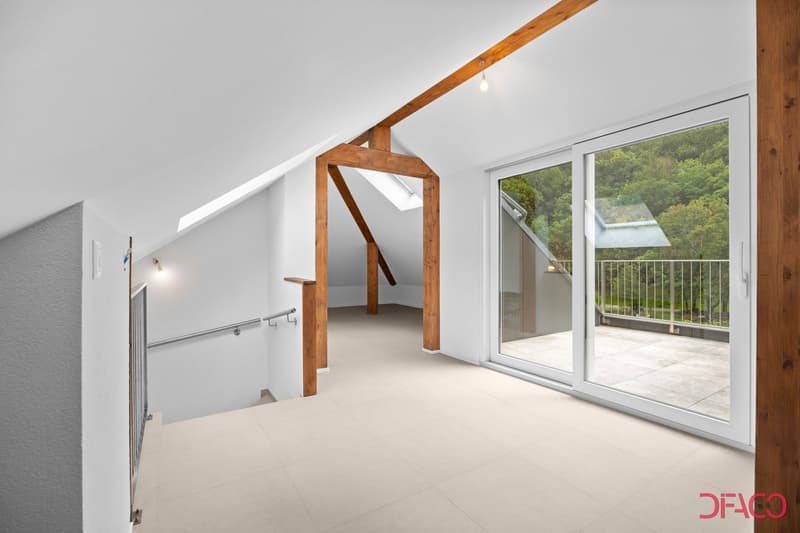 large attic room, wooden beams, sliding glass doors, tiled floor, access to balcony