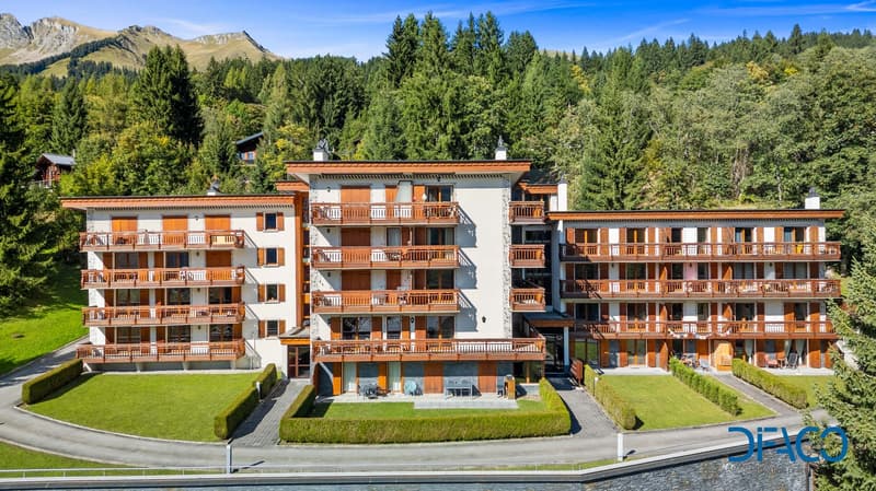Apartment building, wooden balconies, well manicured grass, views of the mountains, gated community