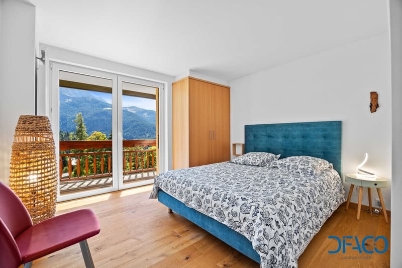 large bed, wooden floor, glass windows, wooden cabinet, bed cover, chair, balcony
