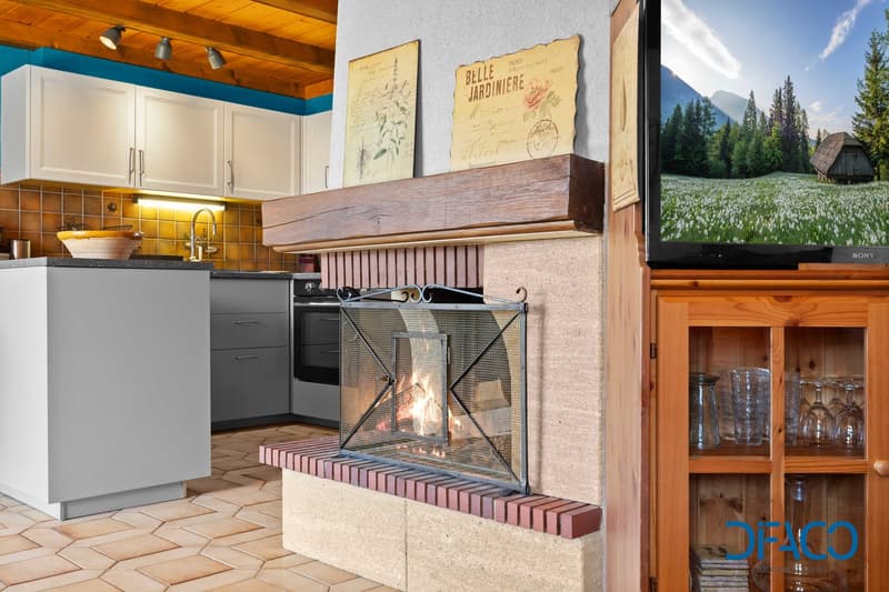 Kitchen with fireplace, tiles flooring, wooden cabinets, TV, kitchenware