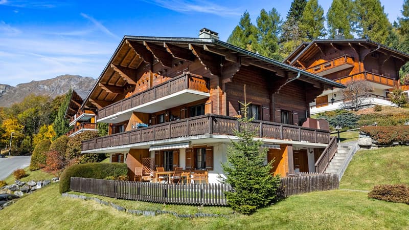 wooden chalet style, 2 story, 3 balconies, wooden fence, outdoor dining table
