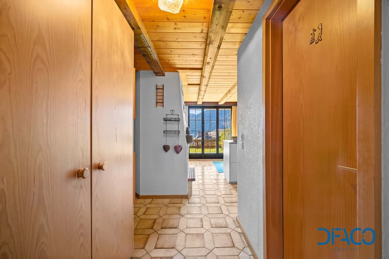 Wooden doors, wooden ceiling, tiled floor, wooden window frame, kitchen with dishwasher
