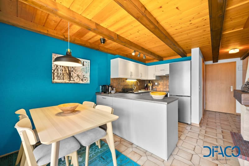 kitchen, dining table, chairs, blue wall, wooden ceiling, white cabinets, fireplace
