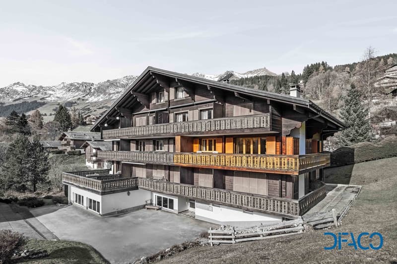 3 story chalet, wooden exterior, multiple balconies, driveway