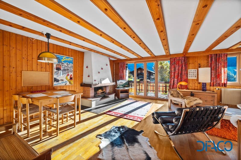 Wooden wall and ceiling, carpet, fireplace, table and chairs, couch, rug, radiator