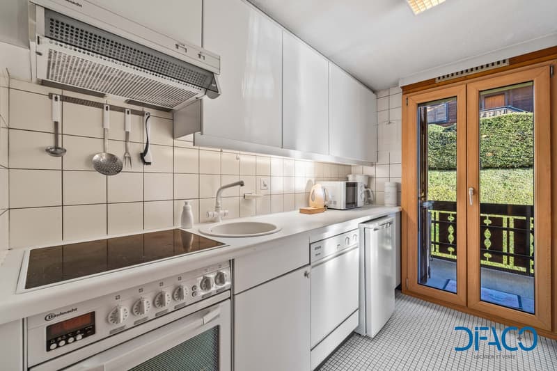 modern design, white appliances, granite countertop, wooden cabinet, glass door, balcony