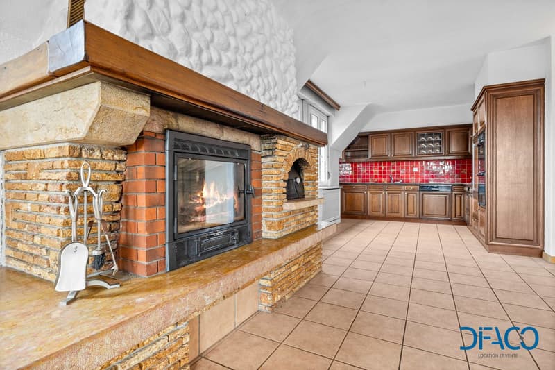 Fireplace, brick wall, tiled floor, kitchen with red tiles, wooden cabinets
