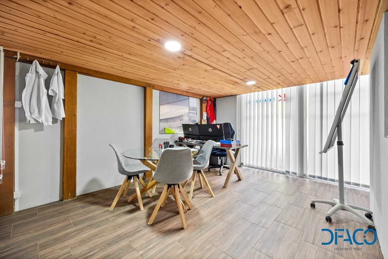 Wooden ceiling, white walls, wooden floor, glass table, chairs, desk, computer, whiteboard, white curtains