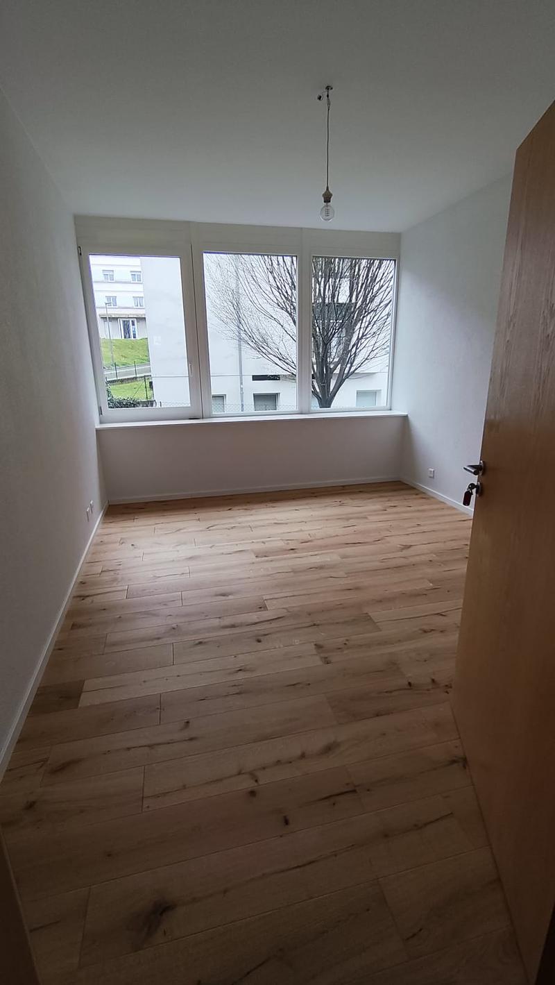 empty room, wooden floor, white walls, large windows, view of outside