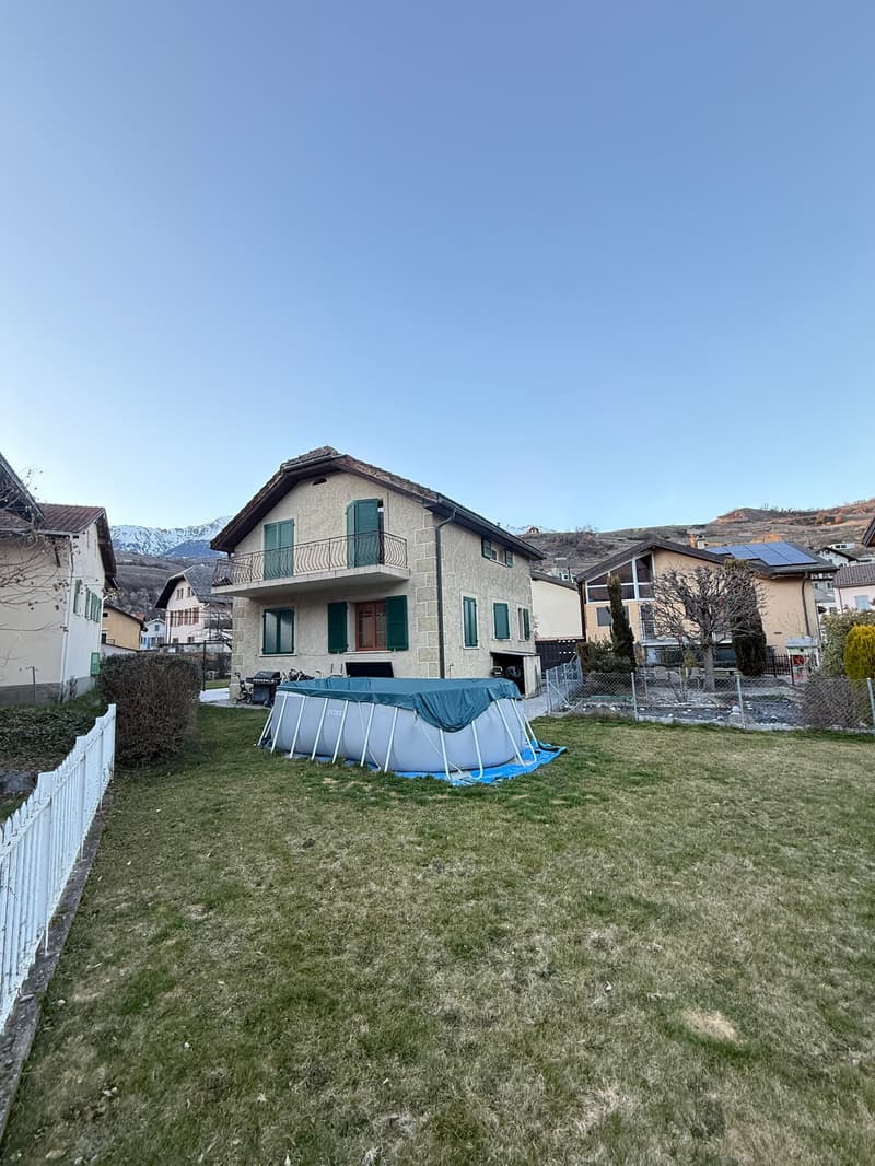 2 story house, green shutters, white windows, balcony, private outdoor grill, covered pool, solar panels