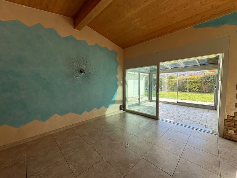 empty room, blue wall, wooden ceiling, tiled floor, sliding glass door, outdoor terrace