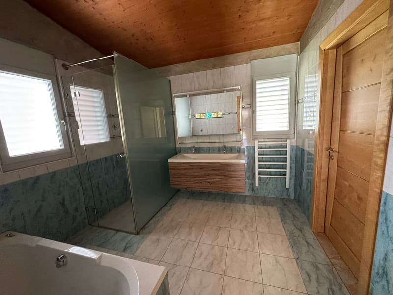 modern bathroom with bathtub, shower, double sink, wooden cabinet, wooden ceiling, tiled floor, windows with shutters