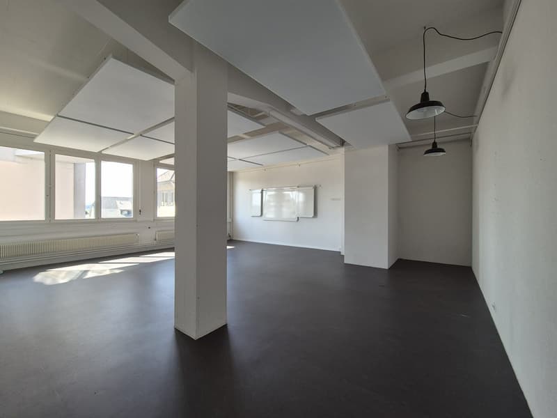 Empty room, white walls, black floor, white ceiling, three lamps, radiators, three windows