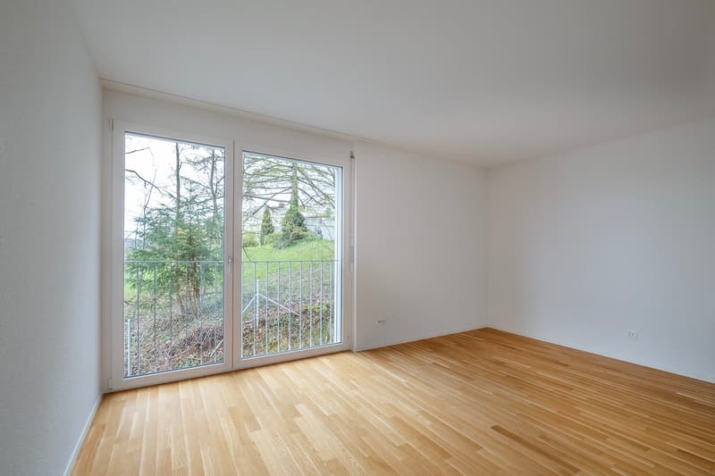 empty room, wooden floor, sliding glass doors, balcony, white walls, power outlets