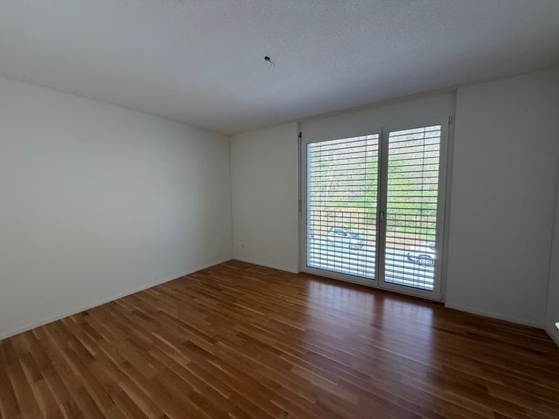 empty room, wooden floor, white walls, sliding glass door, power outlet