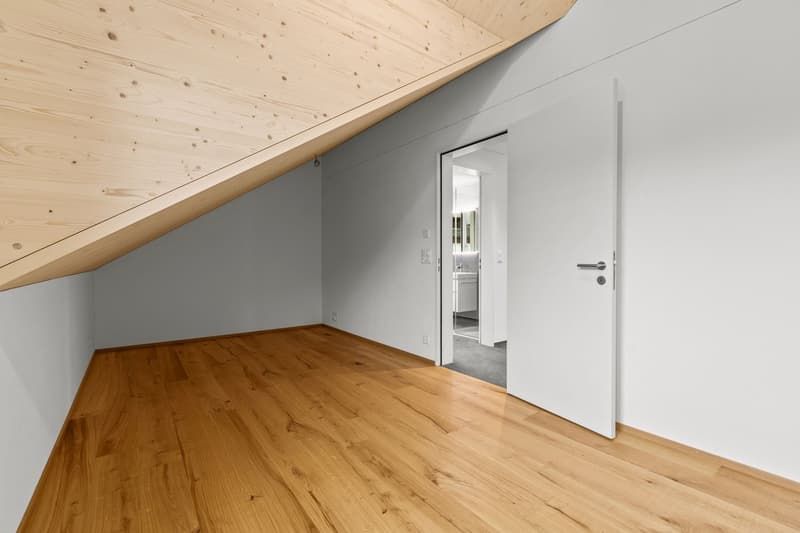 empty room with wooden ceiling and floor, open door