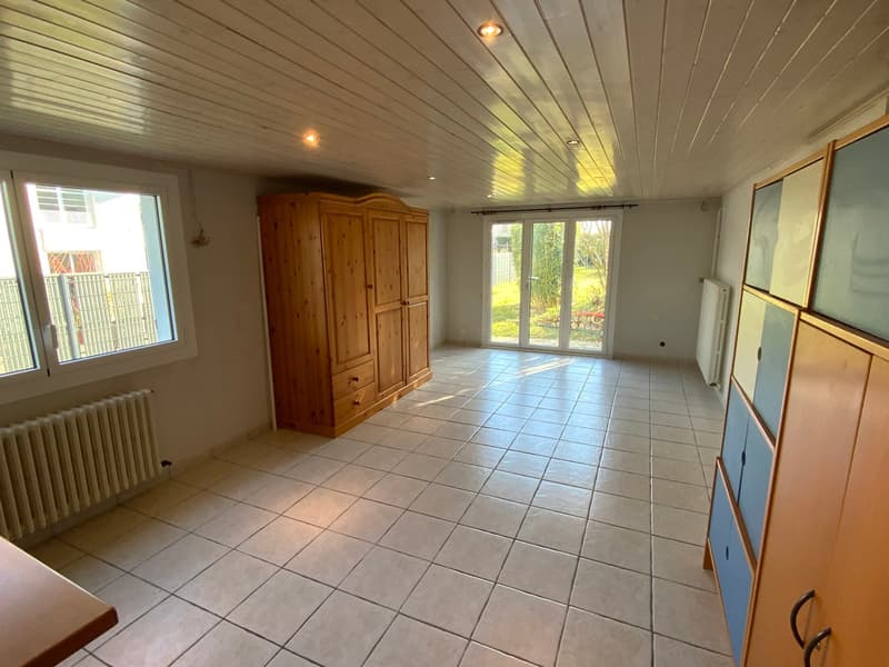empty room with wooden cabinet, white tiles, large windows, radiators