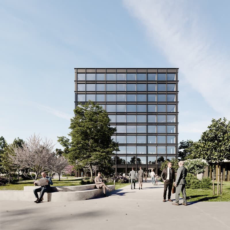 A modern multi-story office building with a glass facade, surrounded by trees and greenery. People are walking on the path in front of the building.