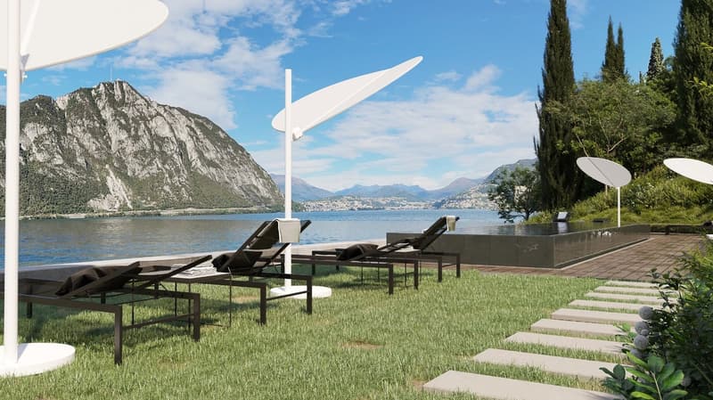 Outdoor lounge area with lounge chairs, umbrellas, and a pool overlooking a lake and mountains