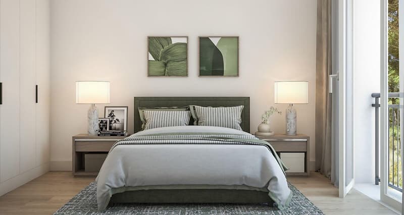 Bedroom with a bed, nightstands, and lamps. Decorated with picture frames, and flower vases. Wooden floors and white walls. It has access to a balcony.